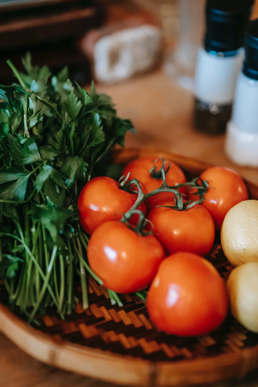 Foods in the Bible: table with tomatoes and herbs with lemons in kitchen